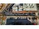 Aerial view shows parking area adjacent to the brick Glen Iris Lofts building at 650 Glen Iris Ne Dr # 27, Atlanta, GA 30308