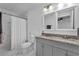 Modern bathroom with double vanity, granite countertop, tiled shower, and decorative mirrors for added style at 2912 Palm Dr, Atlanta, GA 30344