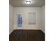 Bright room with white walls and dark floors, featuring a door to the exterior and a window at 6608 Saint Jude Dr, Fairburn, GA 30213