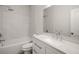 This bathroom offers a tub and shower with white marble tile, a modern vanity and fixtures at 3165 Dogwood Dr # 106, Hapeville, GA 30354