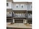 Rear exterior view of modern townhouses with balconies and garages at 3165 Dogwood Dr # 106, Hapeville, GA 30354