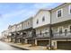 Rear exterior view of modern townhouses with balconies and garages at 3165 Dogwood Dr # 106, Hapeville, GA 30354