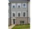 Attractive townhouse with a gray facade and a charming brick base, showcasing classic architectural details at 3165 Dogwood Dr # 106, Hapeville, GA 30354