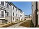 Exterior row of townhomes with sidewalks and landscaping against a blue sky at 3165 Dogwood Dr # 106, Hapeville, GA 30354