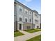 Charming townhouse showcasing a gray and brick facade, complemented by a well-manicured lawn and a sidewalk at 3165 Dogwood Dr # 106, Hapeville, GA 30354