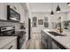 Modern kitchen featuring stainless steel appliances, a waterfall island, pendant lighting, and neutral-toned cabinets at 3165 Dogwood Dr # 106, Hapeville, GA 30354