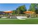 Outdoor park setting with orange umbrellas, seating and lush green lawn, perfect for relaxation at 3165 Dogwood Dr # 106, Hapeville, GA 30354