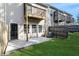 Backyard featuring a wooden fence, green grass, a patio, and a view of the balconies at 323 Sweetshrub Dr, Austell, GA 30168