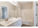 Bright bathroom featuring a double sink vanity with white cabinets and a shower-tub combination at 323 Sweetshrub Dr, Austell, GA 30168