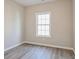 A bright bedroom with clean neutral paint and luxury vinyl flooring and a window at 323 Sweetshrub Dr, Austell, GA 30168