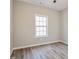 A bright bedroom with clean neutral paint and luxury vinyl flooring and a window at 323 Sweetshrub Dr, Austell, GA 30168