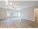 Bright living room with wood-look flooring, large windows, and a view of the staircase at 323 Sweetshrub Dr, Austell, GA 30168