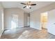 Main bedroom featuring a ceiling fan, wood-look floors, and an ensuite bathroom at 323 Sweetshrub Dr, Austell, GA 30168