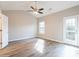 Primary bedroom with wood-look floors, ceiling fan, and access to the outdoors at 323 Sweetshrub Dr, Austell, GA 30168