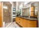 Spa-like bathroom with granite counters, double sinks, glass shower, and travertine floors at 3235 Roswell Ne Rd # 917, Atlanta, GA 30305