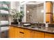 Elegant bathroom featuring double vanity, granite countertop, glass shelving and large glass shower with stone surround at 3235 Roswell Ne Rd # 917, Atlanta, GA 30305