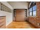 Bedroom with hardwood floors, exposed brick wall, Murphy bed, black trimmed windows with views at 3235 Roswell Ne Rd # 917, Atlanta, GA 30305