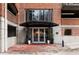 Brick building entrance with covered awning, glass doors, and large potted plants at 3235 Roswell Ne Rd # 917, Atlanta, GA 30305