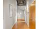 Hallway with hardwood floors, modern lighting, and walls adorned with artwork at 3235 Roswell Ne Rd # 917, Atlanta, GA 30305