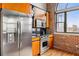 Modern kitchen featuring stainless steel appliances, custom cabinetry, and exposed brick wall at 3235 Roswell Ne Rd # 917, Atlanta, GA 30305