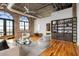 Open living room with hardwood floors, exposed brick, custom built-ins, and natural light at 3235 Roswell Ne Rd # 917, Atlanta, GA 30305