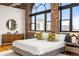 The main bedroom boasts exposed brick, hardwood floors, and lots of natural light at 3235 Roswell Ne Rd # 917, Atlanta, GA 30305