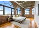 This stunning main bedroom features exposed brick, hardwood floors, and large arched windows at 3235 Roswell Ne Rd # 917, Atlanta, GA 30305