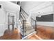 Bright foyer with hardwood floors, staircase, and views into the dining room at 3819 Trotters Run, Douglasville, GA 30135