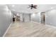 Spacious open-concept living area featuring sleek floors, a ceiling fan, and seamless access to the kitchen and other rooms at 3819 Trotters Run, Douglasville, GA 30135