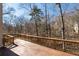 Large wooden deck with wooden railing surrounded by mature trees at 3854 W Nancy Creek Ne Pl, Brookhaven, GA 30319