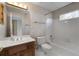 A full bathroom showcasing an oak vanity, built-in tub, and tile flooring at 3854 W Nancy Creek Ne Pl, Brookhaven, GA 30319