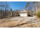 Charming house with a two-car garage, a spacious driveway, and mature trees at 3854 W Nancy Creek Ne Pl, Brookhaven, GA 30319