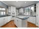 Charming kitchen featuring white cabinets, hardwood floors, and an island cooktop at 3854 W Nancy Creek Ne Pl, Brookhaven, GA 30319