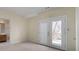 Spacious main bedroom featuring a view of the outside deck through glass doors and an ensuite bathroom at 3854 W Nancy Creek Ne Pl, Brookhaven, GA 30319