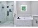 Bathroom with marble tile, glass shower enclosure and soaking tub at 419 Mcinnes Se Cir, Marietta, GA 30060