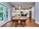 Dining room with modern table, leading to a modern kitchen with stainless steel appliances at 419 Mcinnes Se Cir, Marietta, GA 30060