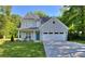 Charming two-story home with a well-manicured lawn, attached two-car garage and a welcoming blue front door at 419 Mcinnes Se Cir, Marietta, GA 30060