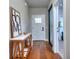 Inviting hallway with wood floors, showcasing a decorative 'HOME' sign and a view into another room at 419 Mcinnes Se Cir, Marietta, GA 30060