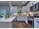 Bright kitchen features white cabinets, stainless steel appliances, quartz countertops, and hardwood floors at 419 Mcinnes Se Cir, Marietta, GA 30060