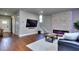 Modern living room with an electric fireplace, hardwood floors, and mounted TV at 419 Mcinnes Se Cir, Marietta, GA 30060