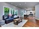 Open concept living room with hardwood floors, large windows, and view to kitchen at 419 Mcinnes Se Cir, Marietta, GA 30060