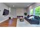 Cozy living room featuring an electric fireplace, hardwood floors, and a comfortable sofa at 419 Mcinnes Se Cir, Marietta, GA 30060