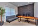 Modern office space with textured wall, large window, and gray futon at 419 Mcinnes Se Cir, Marietta, GA 30060