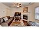 Cozy living room features a fireplace, ceiling fan, and hardwood floors at 3981 Isaac Ct, Lilburn, GA 30047