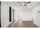 Airy bedroom with tray ceilings, wood-look floors, and a doorway leading to the en-suite bathroom at 40 Joolio Dr, Rockmart, GA 30153