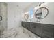 Bathroom featuring double vanity sinks, a glass shower and stone floors at 1137 Hardee Ne St # B, Atlanta, GA 30307