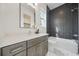 Modern bathroom featuring stylish gray tiled shower, hexagon tile floors, and a gray vanity at 1137 Hardee Ne St # B, Atlanta, GA 30307