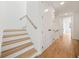 Bright hallway with hardwood floors, staircase, and white trim at 1137 Hardee Ne St # B, Atlanta, GA 30307