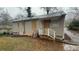 Back view of single-story home with boarded windows, in need of repairs or renovations at 1969 Oak Valley Rd, Decatur, GA 30035