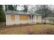 Single-story home with a covered porch and boarded-up windows; in need of renovation at 1969 Oak Valley Rd, Decatur, GA 30035